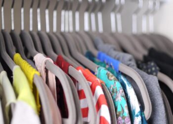 A neat closet with folded and hanging clothes