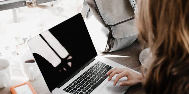 A freelancer working on a laptop at a desk