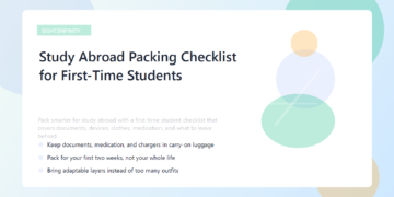 A suitcase packed with study abroad essentials like documents, clothes, adapters, and a laptop.